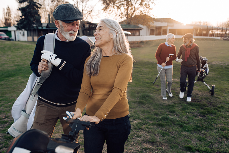 Senior man and woman gathering to play golf with close friends